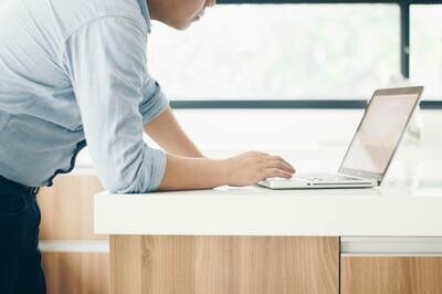CRM demo - man standing with laptop